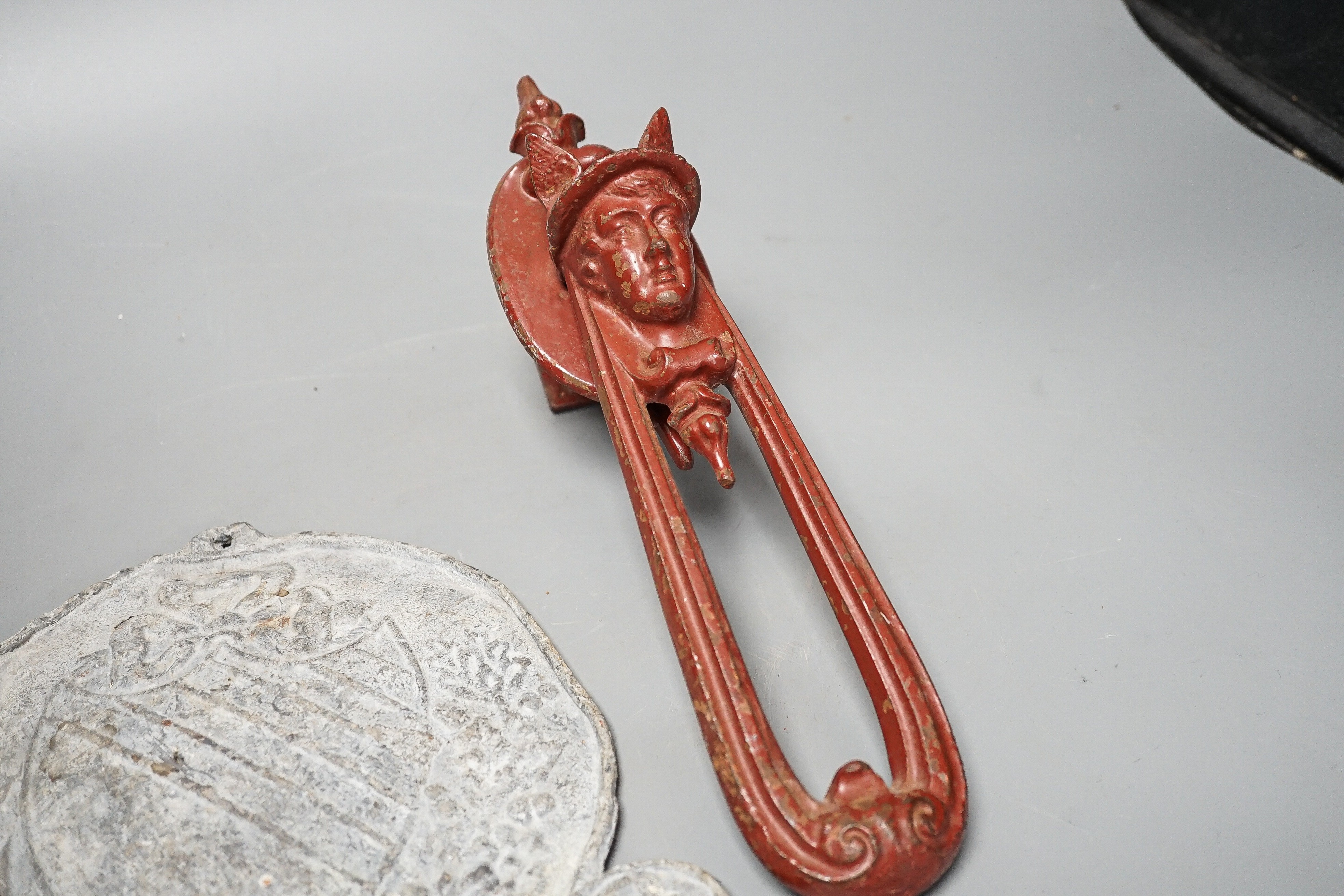 A Manchester lead plaque, 24cm high and a ‘Hermes’ cast iron door knocker